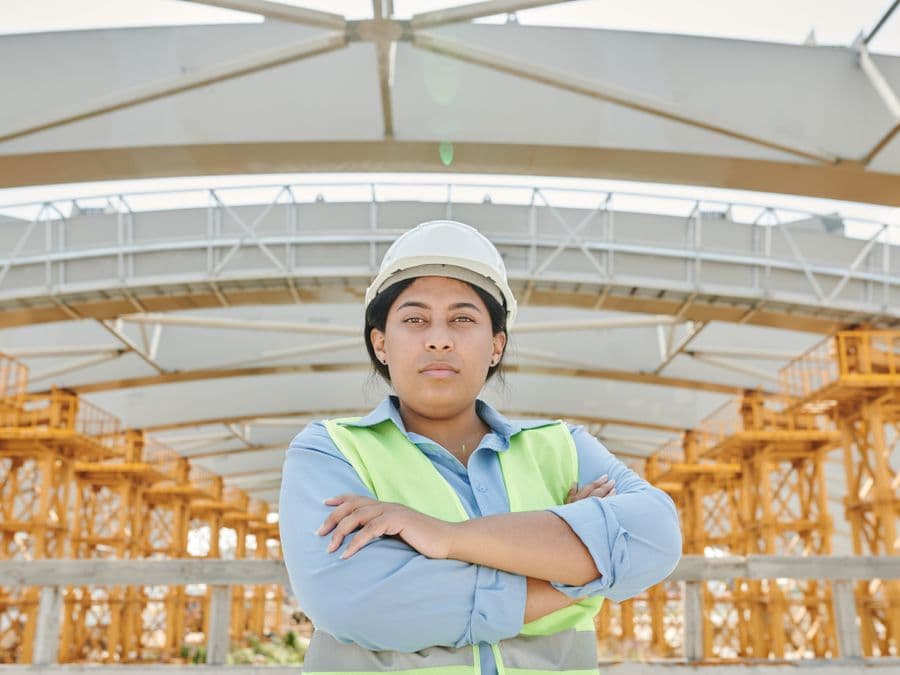 A site engineer in front of a building under construction
