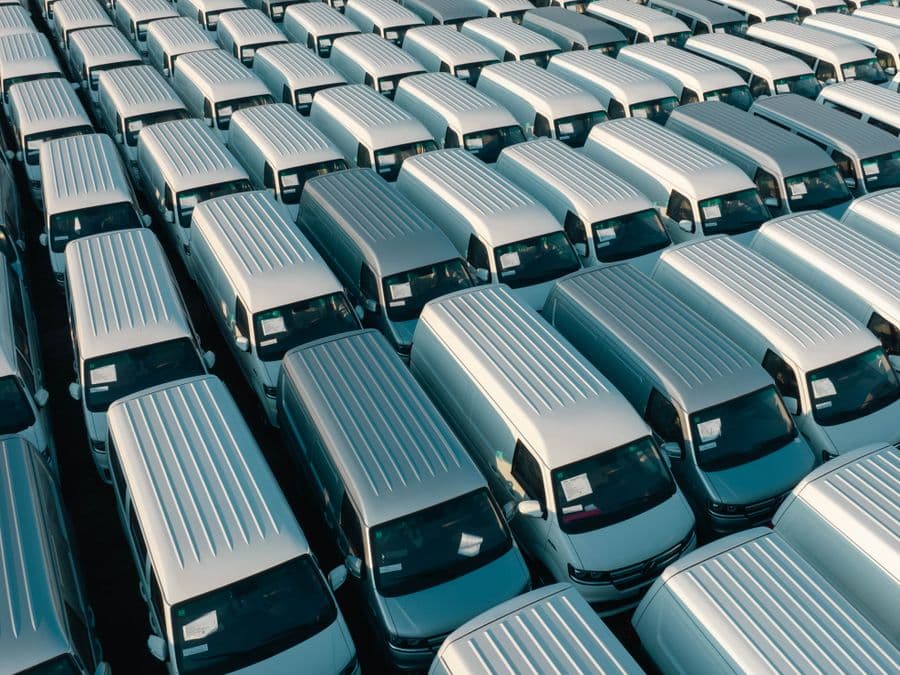 Rows of commercial vans on a dealership lot