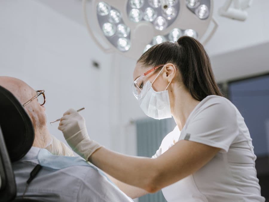 A dentist treating a patient in a clinic