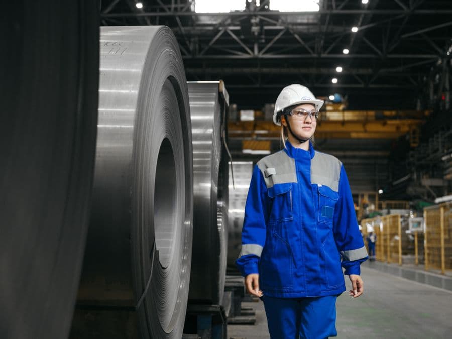 An engineer walking the floor of a steel plant